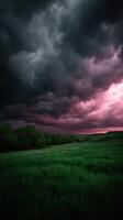 A dark sky with a pink sky and dark clouds photo