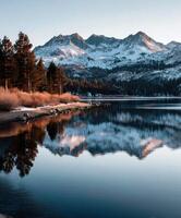 A lake with snow capped mountains in the background photo