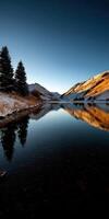 A lake in the mountains with snow on the ground photo