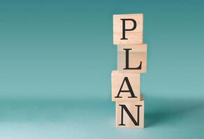 Stack of wooden blocks with the word Plan written on them photo