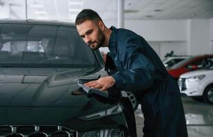 Polishing, the vehicle. Car ,repairman is in the garage with automobile photo