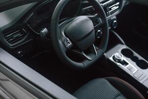 View of the steering, wheel and interior in modern car photo