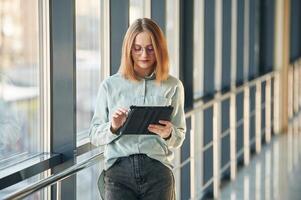 Front, view. Young woman in airport hall photo
