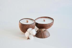 Coconut shape. Handmade beautiful, decorative candles on the background photo