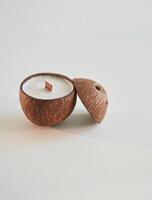 Coconut, shape. Handmade, beautiful decorative candles on the background photo