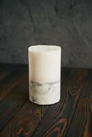 Wooden,,surface. Handmade, beautiful decorative candle on the background photo