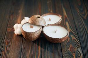 In ,,shape of coconut. Handmade beautiful decorative candles on the background photo