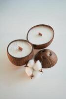 Coconut shape.. Handmade beautiful decorative candles on the background photo