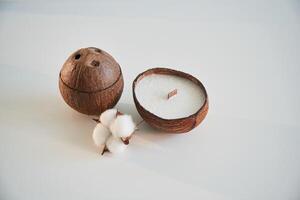 Coconut ,shape. Handmade beautiful decorative candles on the background photo