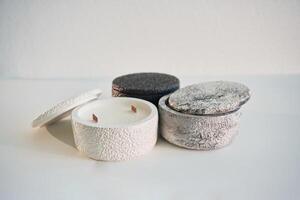 In, capacities. Handmade beautiful decorative candles on the background photo