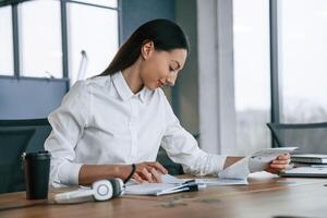 Daily routine, work. Businesswoman is ,indoors in the office photo