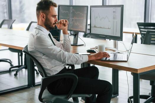 Using laptop. ,Businessman is sitting by computer and working in the office photo