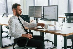 Businessman is sitting ,by, computer and working in the office photo