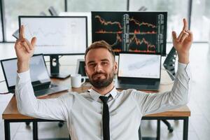 Businessman,, is sitting by computer and working in the office photo