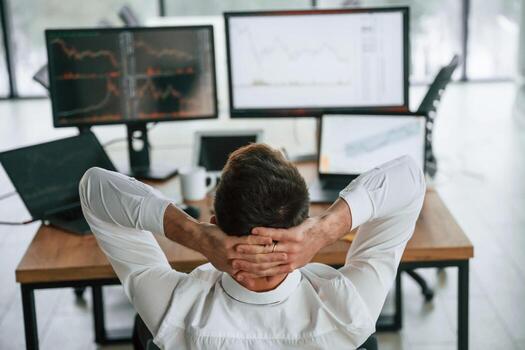 Rear ,view. Businessman ,is sitting by computer and working in the office photo