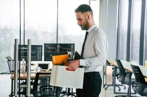 Unemployed man is with personal belongings, after being ,fired photo