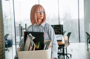 With personal ,belongings, in, the box. Unemployed woman is after being fired photo