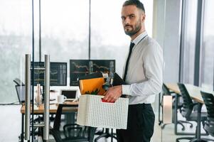 Sad person. Unemployed ,man ,is, with personal belongings after being fired photo