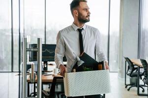 Sad, person. Unemployed, man, is ,with personal belongings after being fired photo