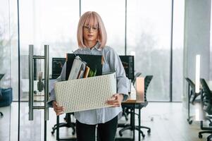 With ,personal belongings in the box. Unemployed woman is after being fired photo