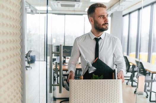 Walking, forward.. Unemployed man is with personal belongings after being fired photo