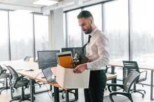 With box, in, hands. Unemployed man is with personal belongings after being fired photo