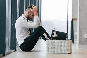 Unemployed, man is with personal belongings after being fired photo