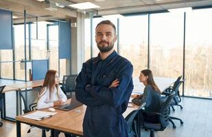 Repairman, is ,standing in the office, employees behind photo