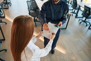 Sign this, document. Man and woman employees are working in the office photo