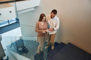 Walking, on, the stairs. Man and woman are on the way to work to office photo