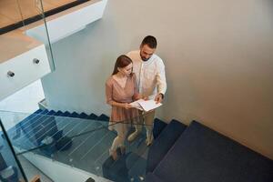 Walking on, the stairs. Man and woman are on the way to work to office photo