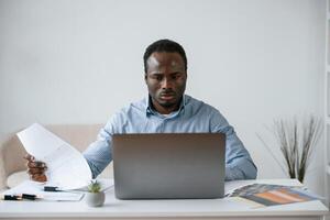 Front,, view. Businessman, is ,working in the office by laptop photo