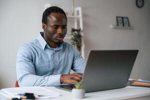Front ,view. Businessman ,,is working in the office by laptop photo