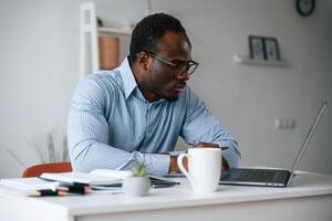 Manager is using laptop. Businessman is working in the office photo