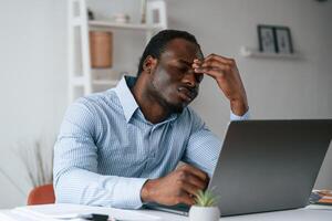 Feeling bad, ,stressful.. Businessman is working in the office by laptop photo