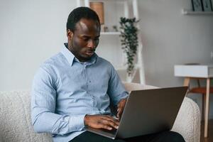 Freelancer is, working at home by laptop photo