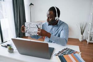 Building the strategy of project. Online meeting. Businessman is working in the office by laptop photo