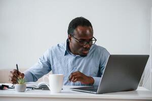 Manager, is using,, laptop. Businessman is working in the office photo