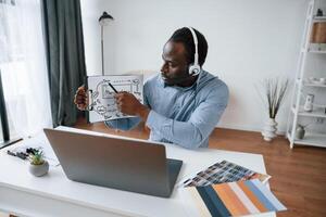 Building, the strategy of project. Online meeting. Businessman is working in the office by laptop photo