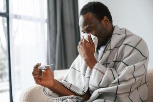 Sick ,black,, man is at home photo