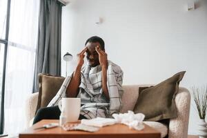 Sick, black, man is at home photo