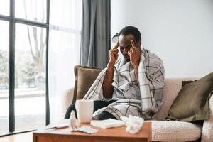 Terrible, flu.. Sick black man is at home photo