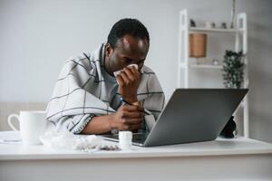 Working, from, home, by laptop. Feeling bad. Sick black man is at home photo