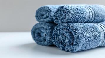 Stack of blue towels on a white table photo