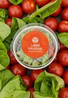 A clear salad container with a label mockup sits nestled amongst fresh lettuce and tomatoes psd