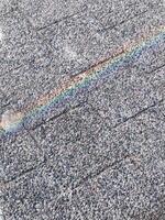 A rainbow is reflected on a gray roof photo