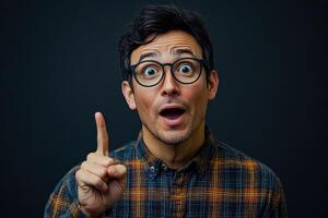 Man with glasses is pointing at something with his finger photo