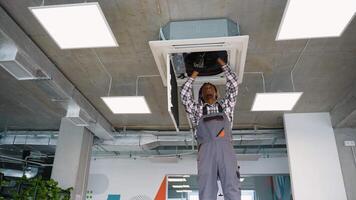 Technician working on ceiling air conditioning system video