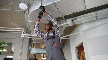 HVAC technician working on office ventilation system video