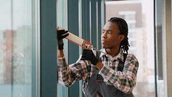 Construction worker applying sealant around window video
